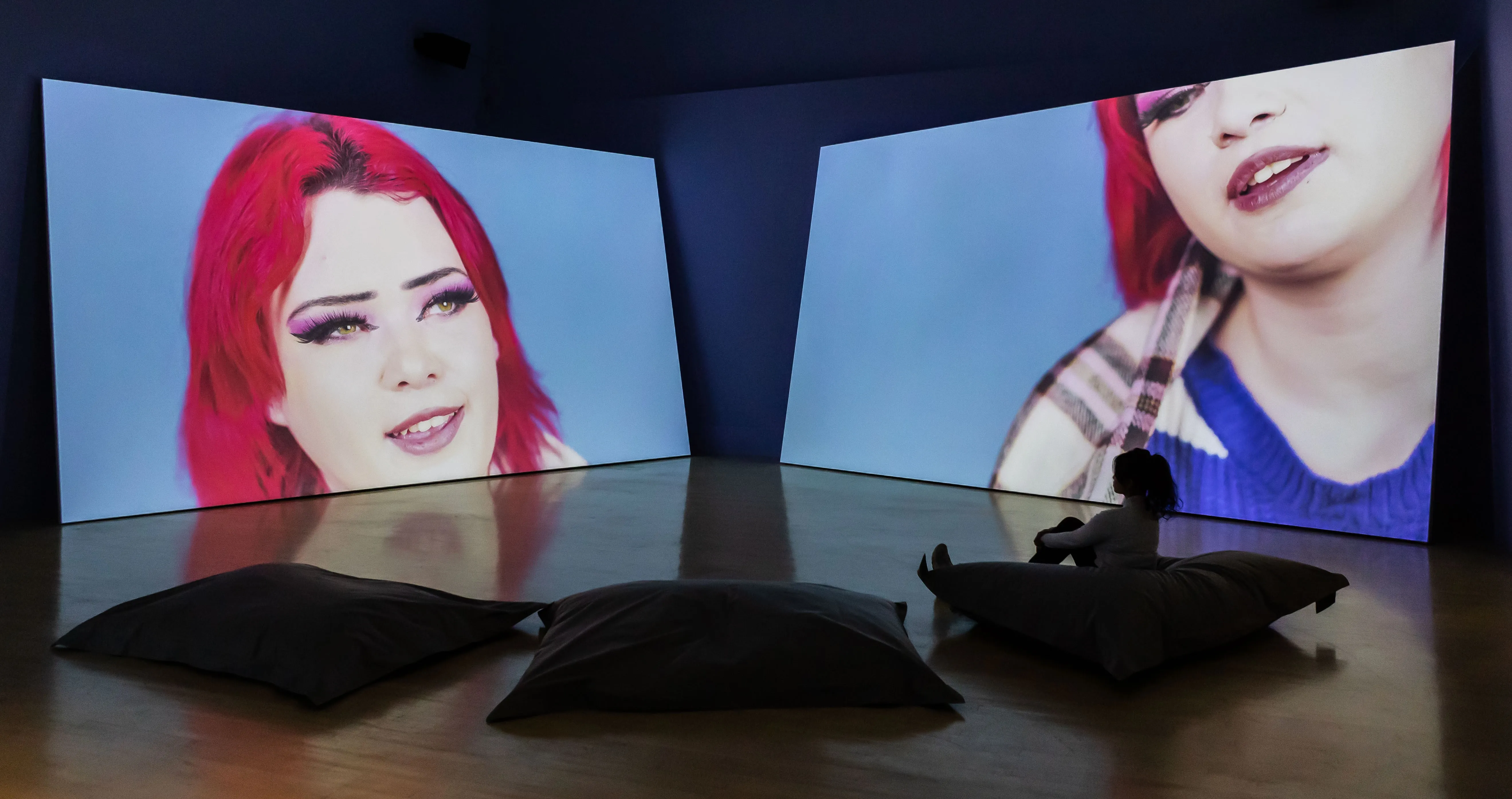 Giant video screen projections in an art gallery space. 