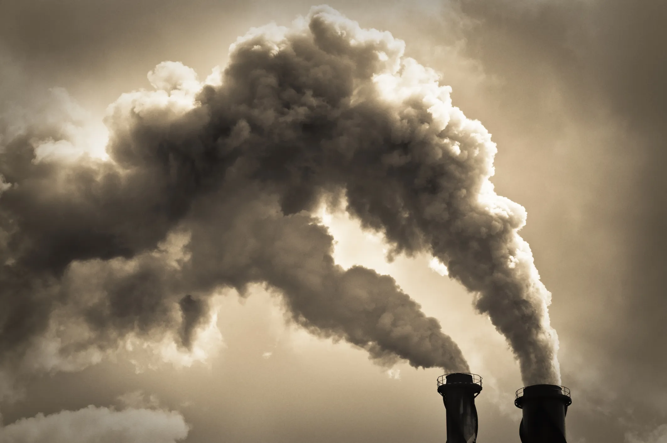 Stock image of two industrial chimneys