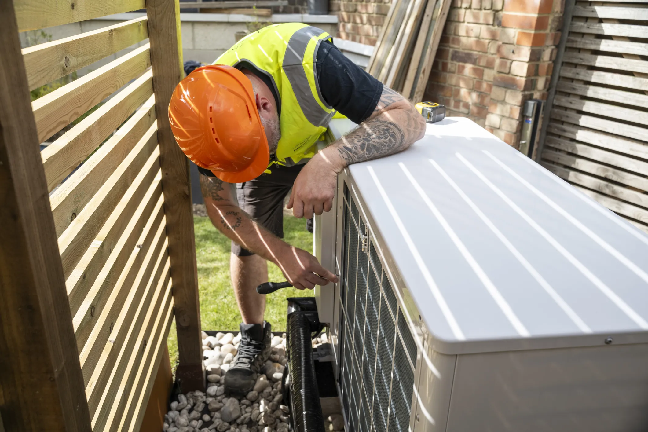 A man installing a heat pump