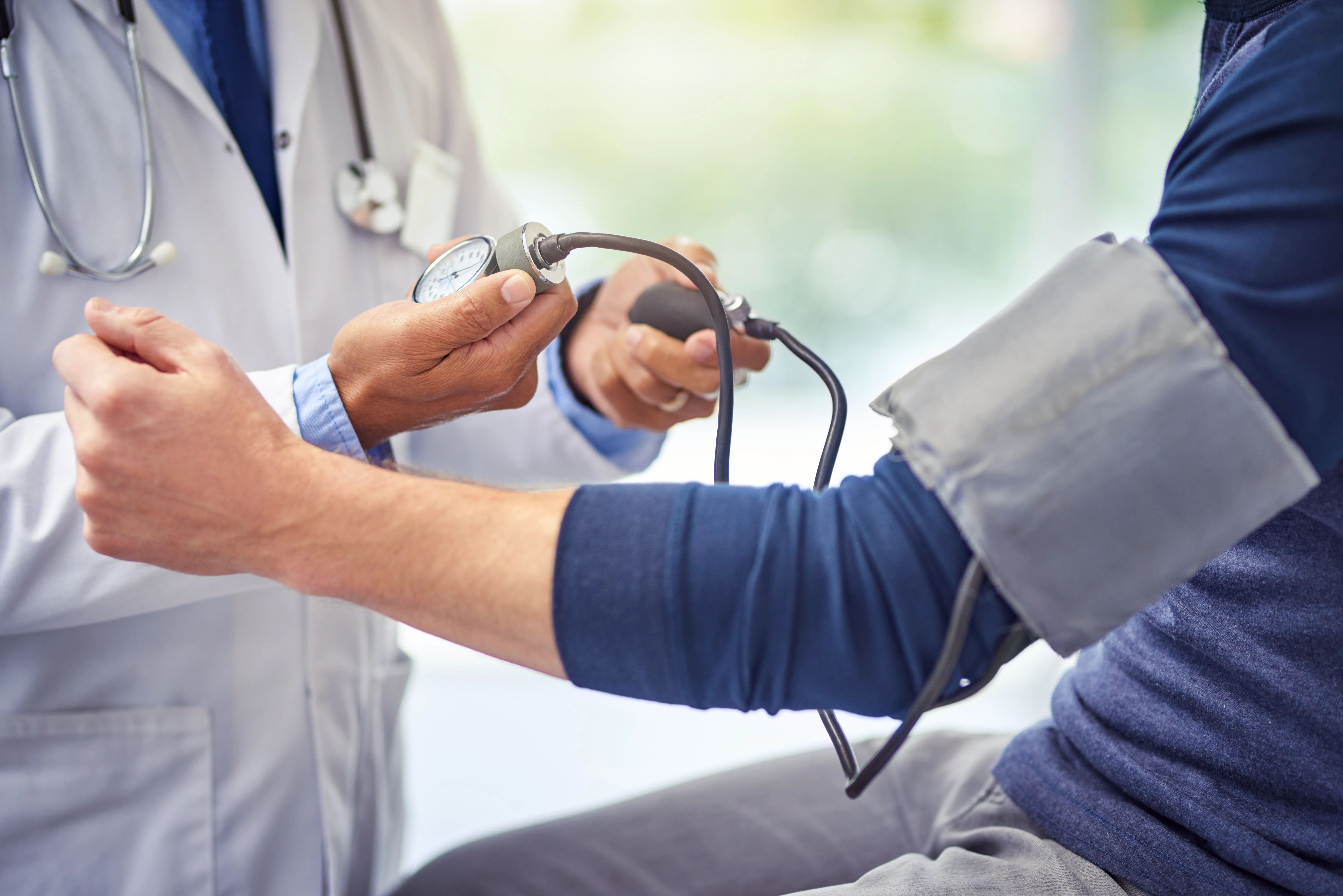 A photograph of a doctor taking the blood pressure of a patient