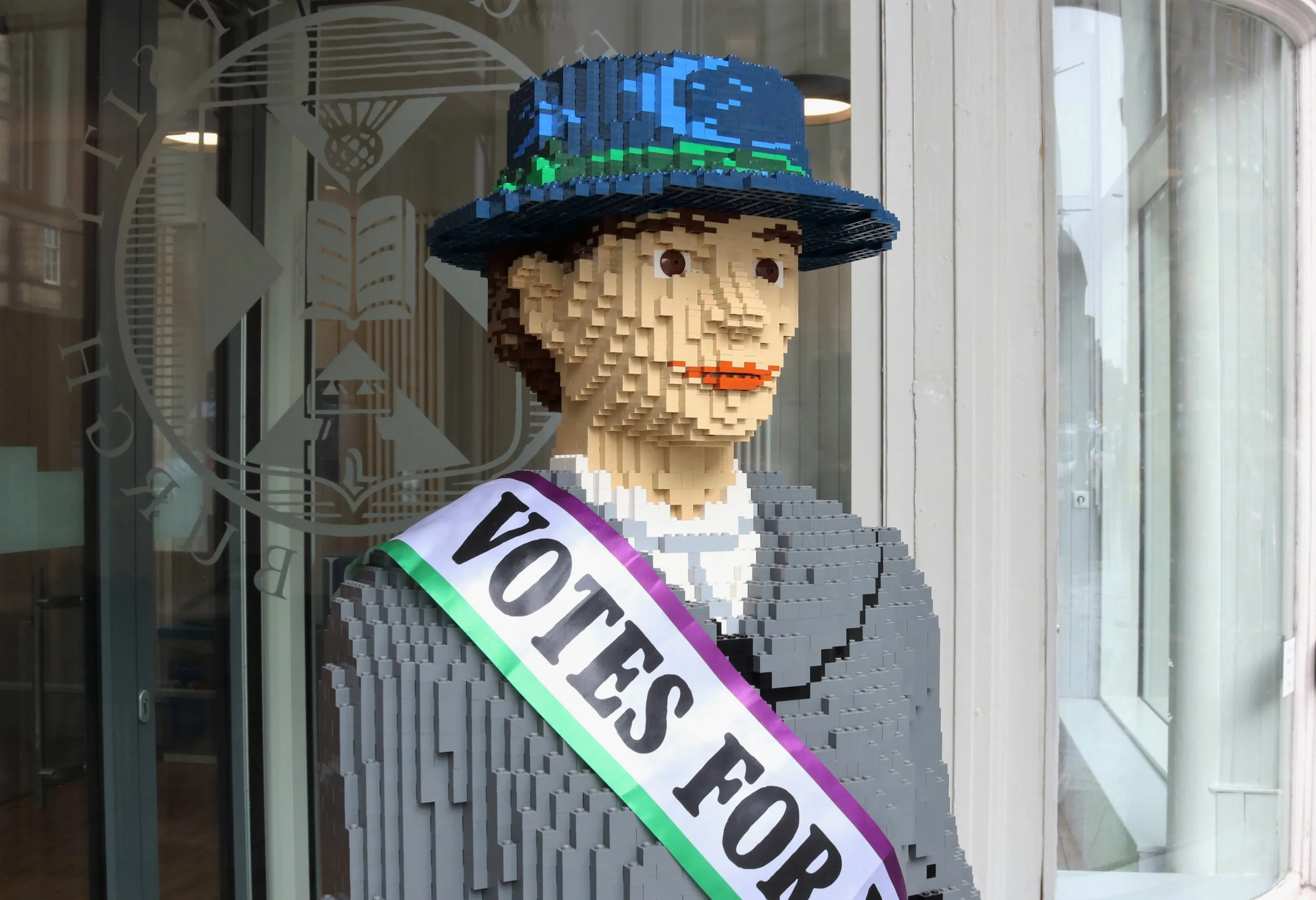 Image of the top of a life sized lego brick statue of a suffragette