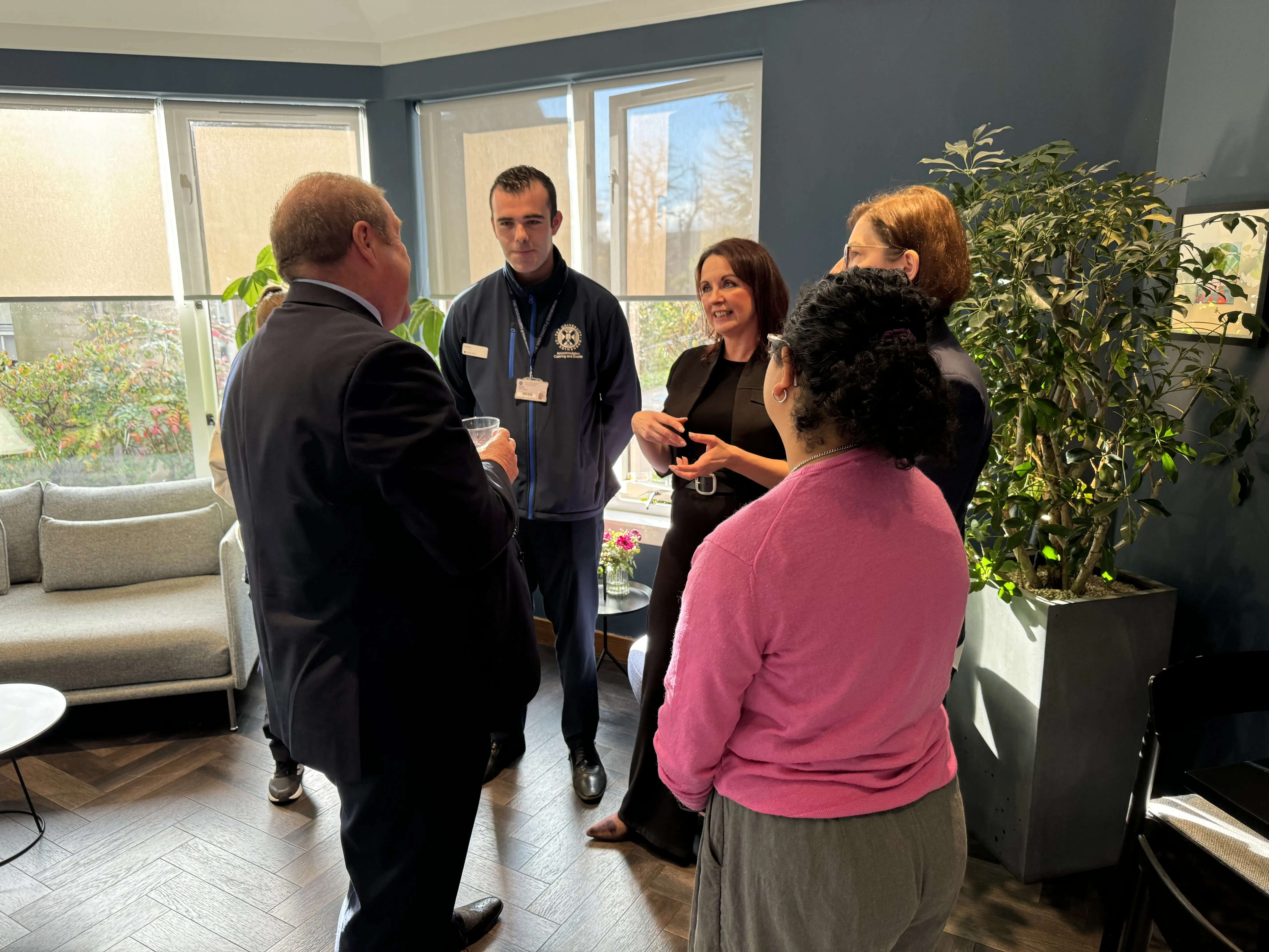 People standing in a group chatting