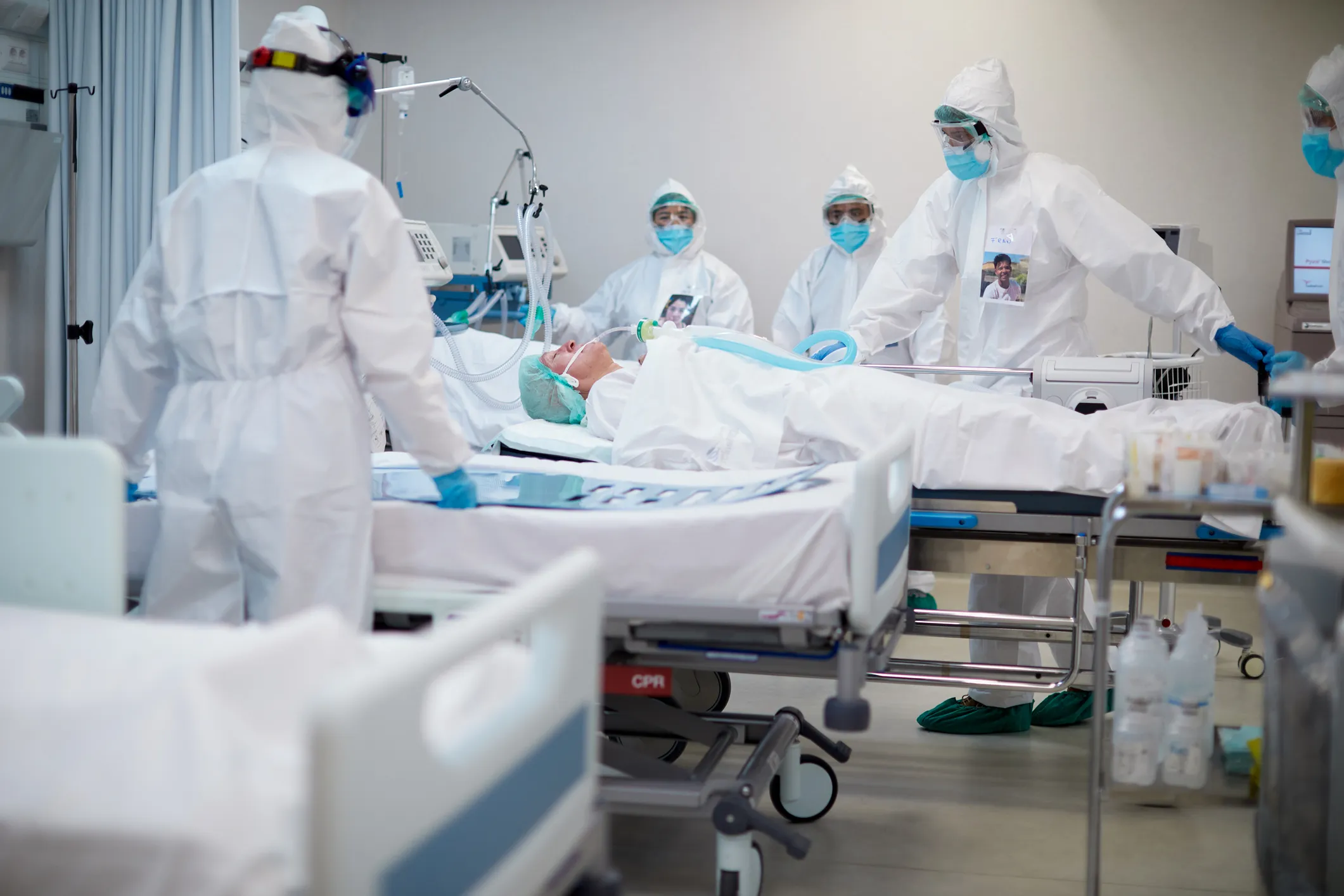 Image of clinical staff in full PPE working on patient in intensive care unit