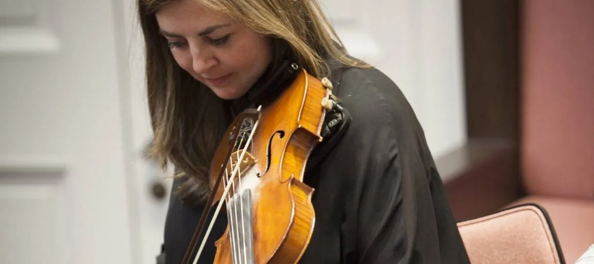 Dr Lori Watson plays the fiddle.