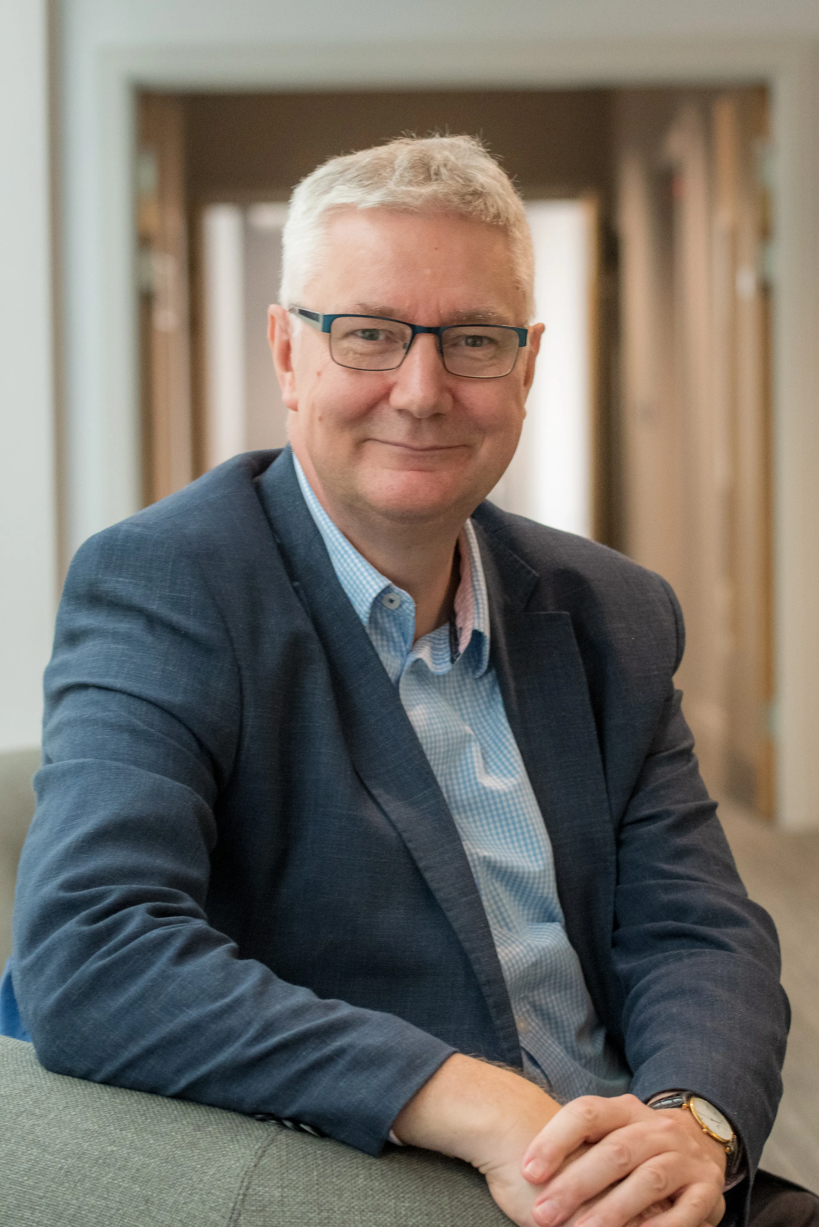 Picture of Professor Andrew Morris seated with hands folded.