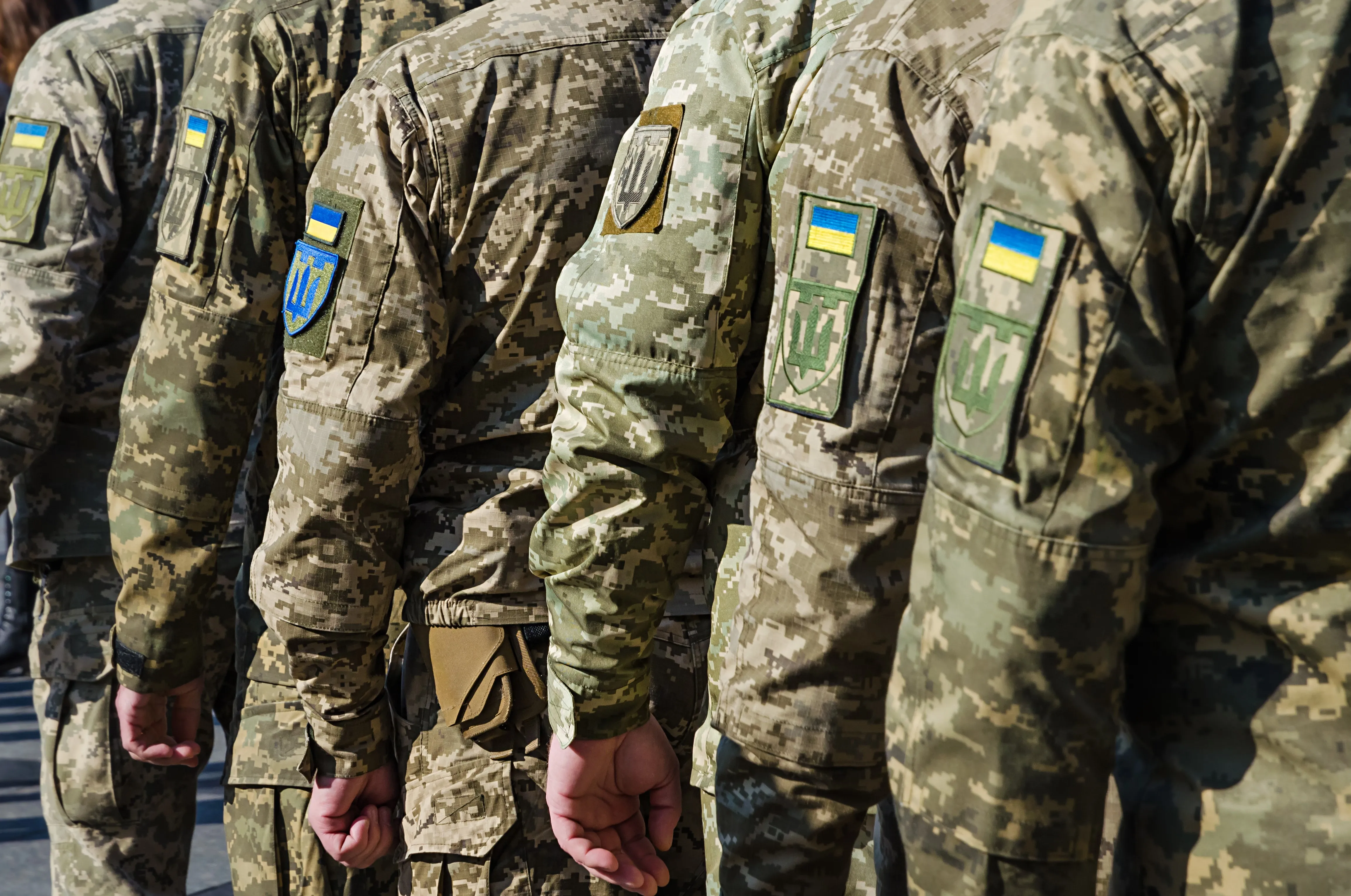 Ukrainian soldiers on military parade. Ukrainian flag on military uniform.