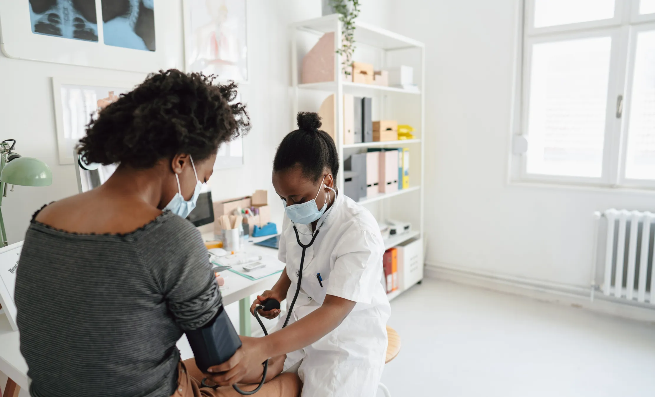 Female doctor checking the patient's blood pressure 