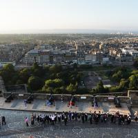 A view of the procession through the castle with the city in the background
