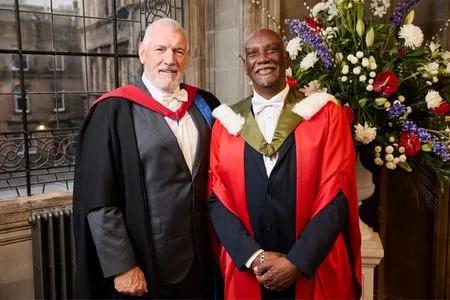 Aston Llewellyn Moore receiving their honorary degree.
