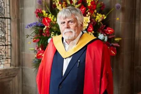 Brian Smith accepting their honorary degree.