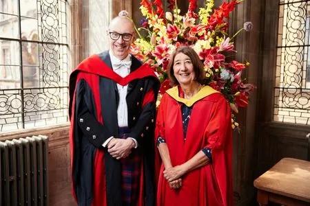 Katie Petty-Saphon receiving their honorary degree.