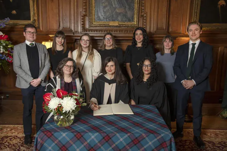 Dora Handrea receiving the Principal's Medal on behalf of Edinburgh Innovations Student Enterprise Team