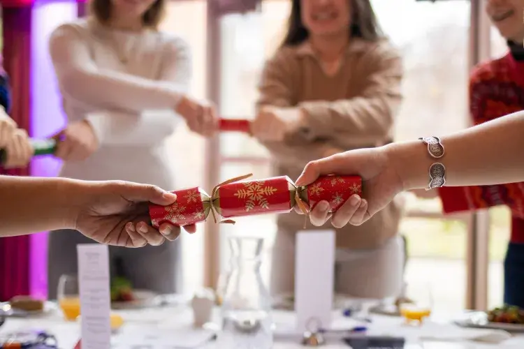 Students holding christmas crackers