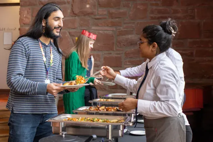 A student is served from the buffet at the University of Edinburgh Festive Lunch