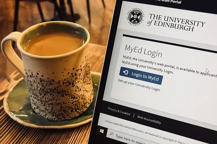 A coffee on a wooden table beside a laptop showing the MyEd homepage