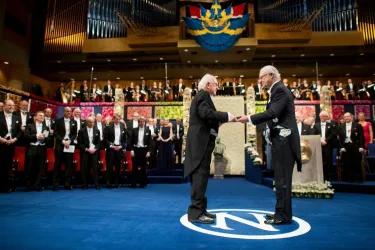 The late Professor Peter Higgs receives his Nobel Prize medal. 