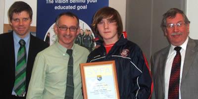 Colin McLeland, Pat Nevin and Prof Hillis presenting the Salvesen FC team captain with a certificate of participation.
