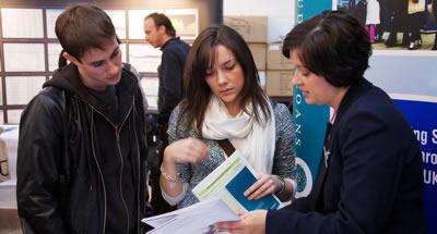 Students talking to an exhibitor at the Edinburgh Graduate Recruitment Fair.