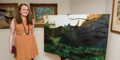 Photograph of artist Morag Donkin standing next to her winning painting