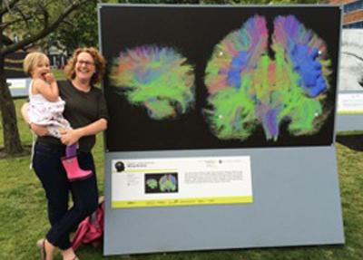 Sue Fletcher-Watson standing next to brain exhibition picture
