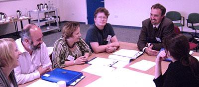 Photo showing several adults in a meeting