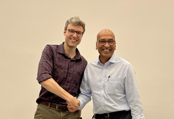 Liam Roebuck receives the Tom Philps Prize from Dr Dilip Patel.