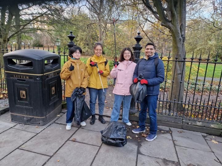 Four students with litter picking equipment