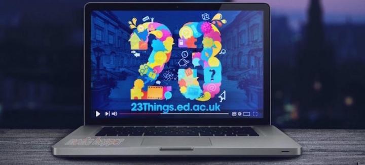 A laptop with the screen displaying a colourful number 23