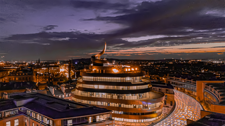 The swirling rooftop of the St James' quarter building in Edinburgh at dusk.