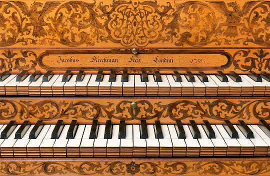 A close up of the keyboard of a Kirkman Harpsichord - showing two keyboards on top of each other.