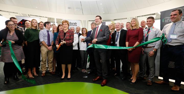 First Minister Nicola Sturgeon cutting the ribbon among a crowd to open the Roslin Innovation Centre.