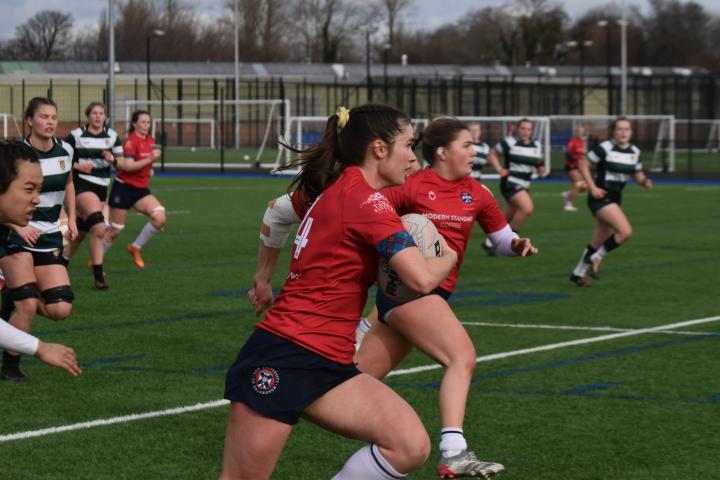 Image of ladies rugby player running with ball 