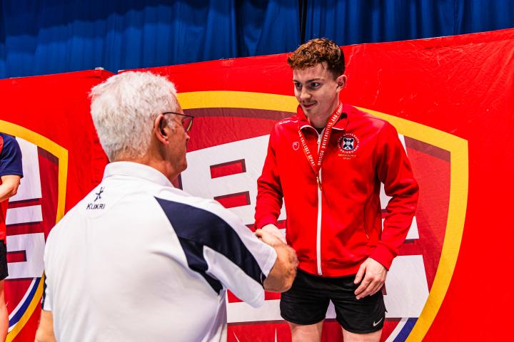 Image of archie goodburn receiving gold medal for swimming