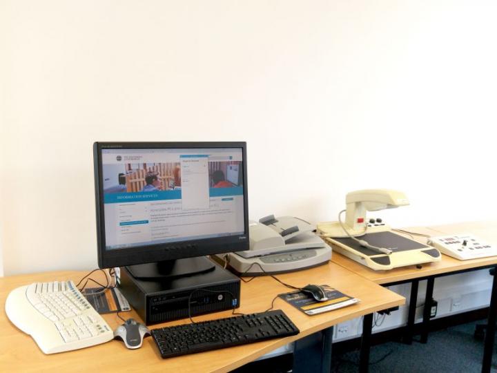 Accessible workstation, Law Library, with CCTV overhead magnifier, document feed scanner, ergonomic keyboard and Trackball mouse