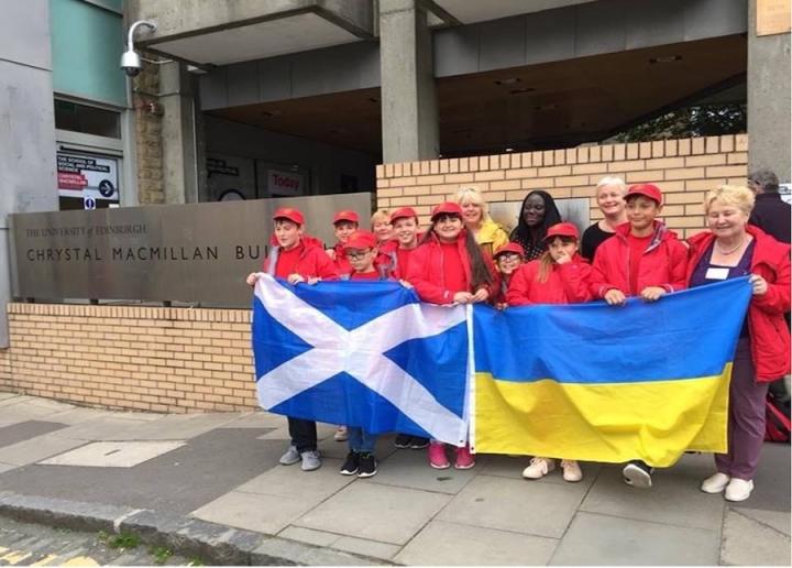 Image of a group of volunteers holding Scottish and Ukrainian flags with the Chernobyl Children Lifeline charity 