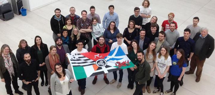 Aerial shot of a group of Celtic Students holding the Celtic Nations flag