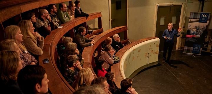 Dick Vet alumni listen to lecture in wooden tiered lecture theatre