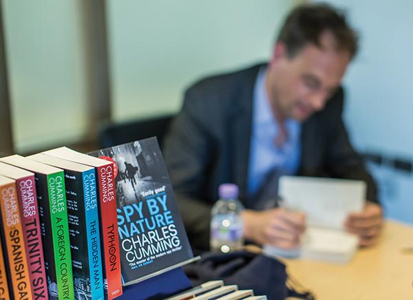 Author signing books in Spy Week Annual review 2014_15 