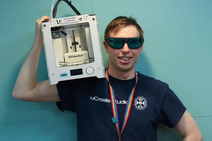 Anthony Middleton uCreate Makerspace Coordinator holding an Ultimaker 2 GO 3D printer