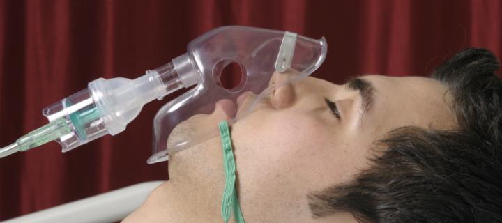 Photograph of man using oxygen mask