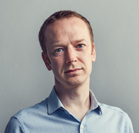 Headshot image of Dr Kenneth Baillie, in light blue collared shirt