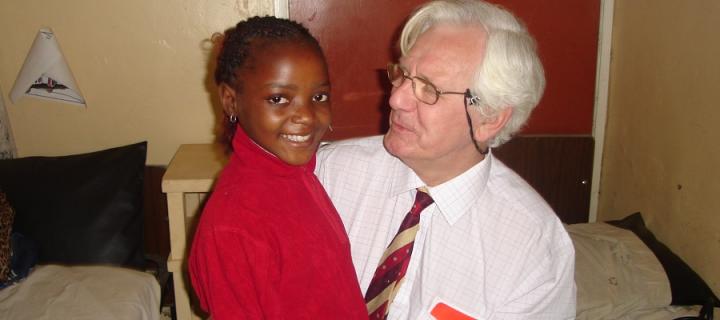 Dr Peter McCormick with a child patient at a hospital in Cameroon