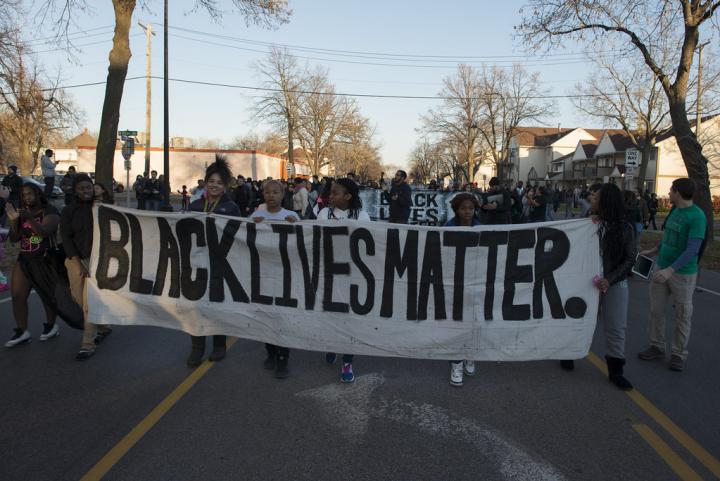 Photograph of a Black Lives Matter protest, with a Black Lives Matter banner. 