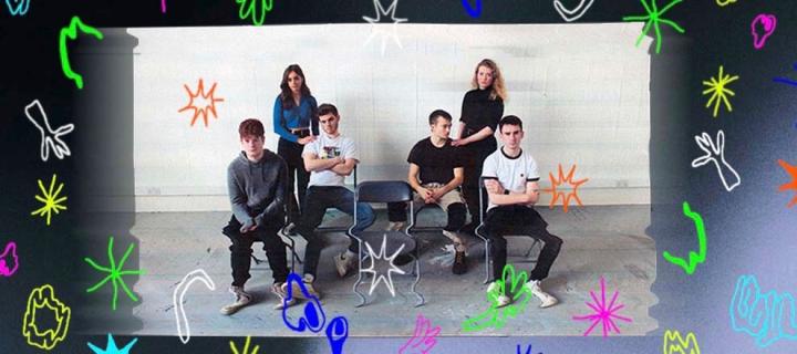 Photo of the cast of the play boys with boys on chairs and girls standing
