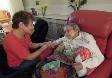 Photo of a carer and a woman in a care home centre