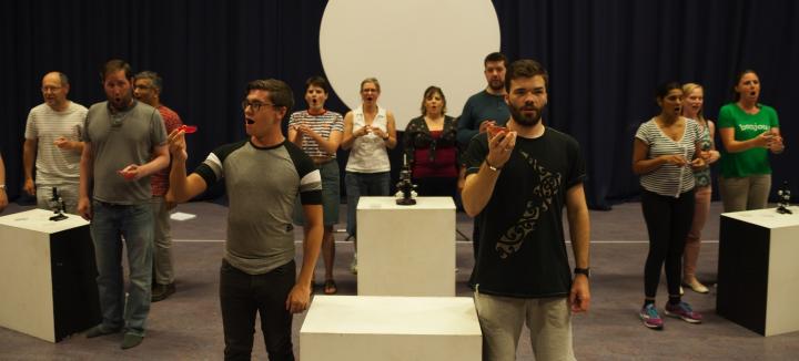 Actors hold up Petri dishes while rehearsing for The Mould that changed the world