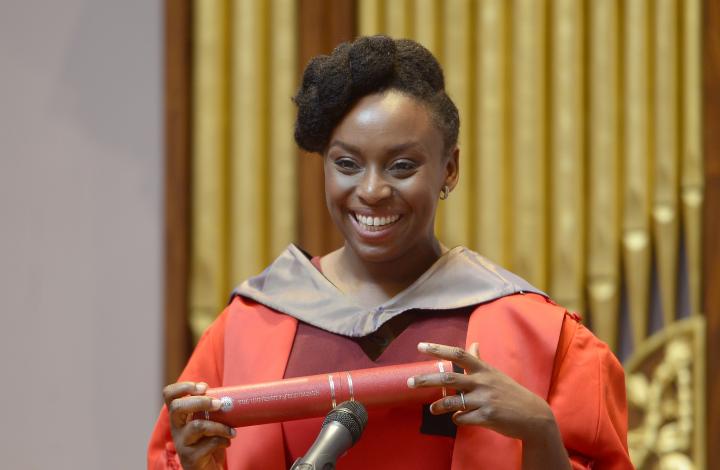 Chimamanda Ngozi Adichie holding her degree scroll