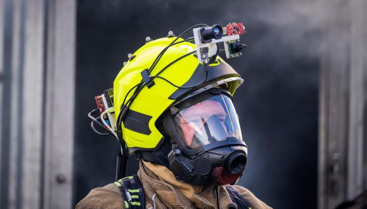 Imafe of a firefigher wearing an A.I. fire helmet developed by the School of Informatics, University of Edinburgh.