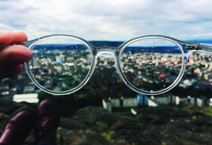 Image of glasses overlooking a city 