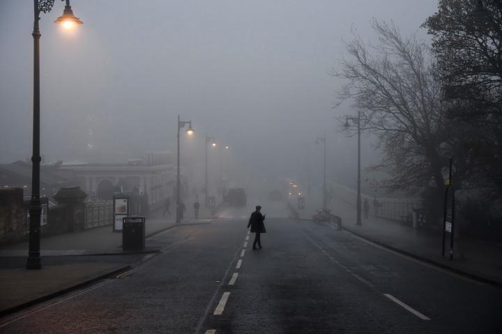 Photo showing a person crossing an Edinburgh street in the mist